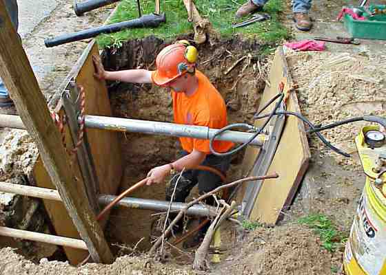 Worker replacing lead pipes in Madison